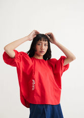 A Model Wearing Red Organic Cotton Ocean Air Organic Cotton Red Top, curated by Only Ethikal